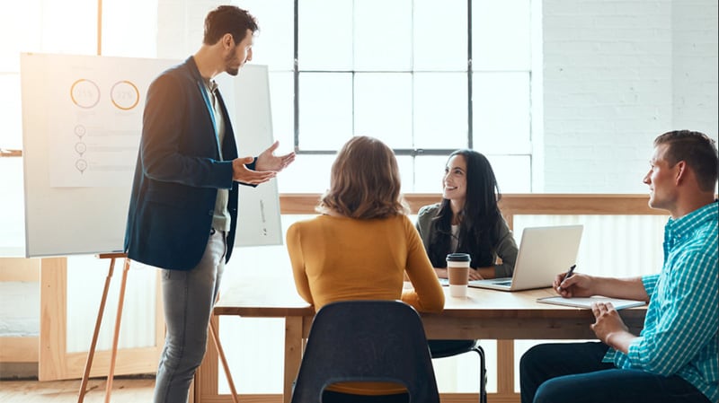 Colleagues discussing in a modern conference room.