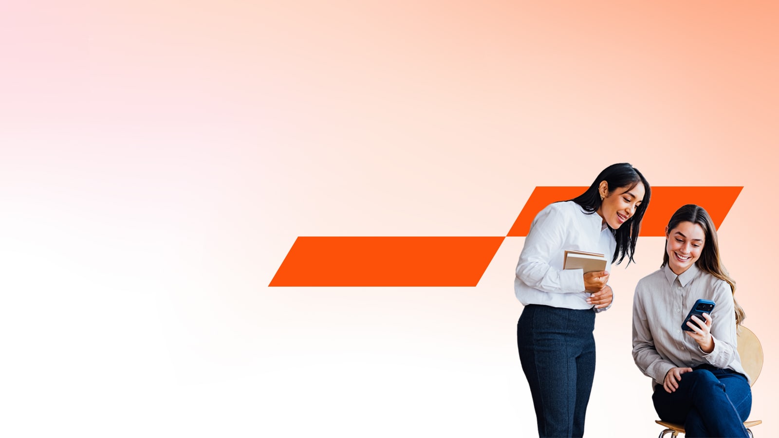 Två kvinnliga glada kollegor tittar på en smartphone.